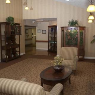A cozy lobby area with seating and bookshelves.