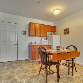 A cozy kitchen with a small dining area featuring a wooden table and chairs.