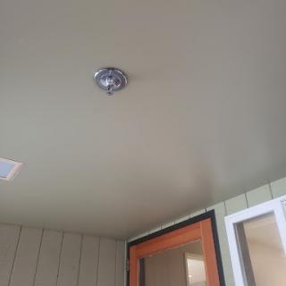 A close-up view of a ceiling featuring a modern light fixture.