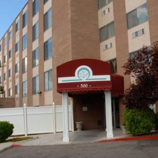 Hotel entrance showcasing modern architecture and a welcoming sign.