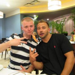 Two friends enjoying a lighthearted moment at a restaurant.