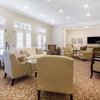 A spacious and elegantly designed living room with comfortable seating arrangements.