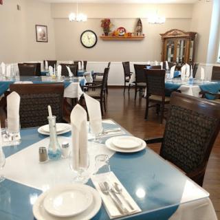 A beautifully arranged dining area with blue table settings and elegant decor.