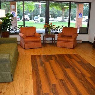 A cozy lobby area with comfortable seating and large windows letting in natural light.