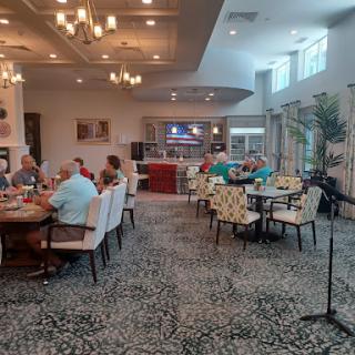 A lively dining area featuring groups of people enjoying a meal together.