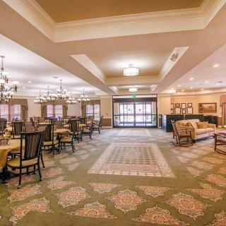 Spacious dining area with elegant furnishings and lighting.
