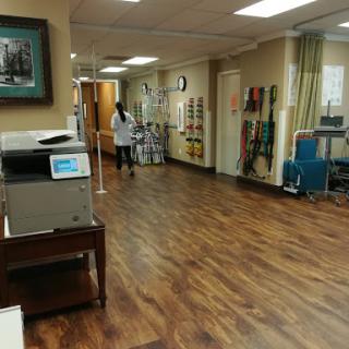 A view of the interior of a medical rehabilitation facility, showcasing a spacious walking area and healthcare equipment.