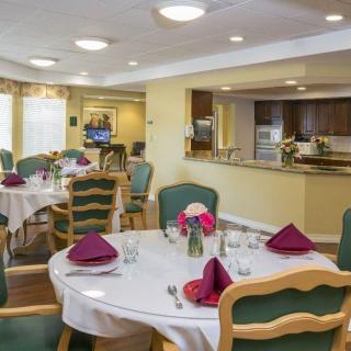 An elegant dining room with set tables and comfortable seating, ready for guests.