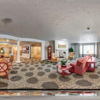 A modern and spacious living room with comfortable seating and bright lighting.