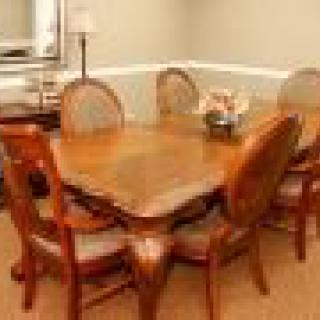A cozy dining area featuring a wooden table and matching chairs.