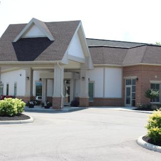 A modern building with a welcoming entrance and landscaped surroundings.