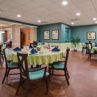 A well-arranged dining area with tables and chairs set for guests.