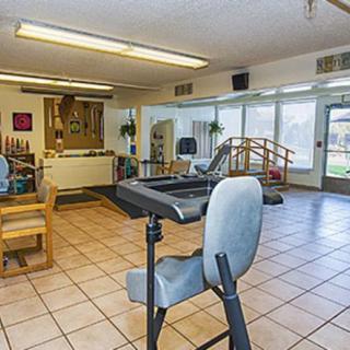 A spacious rehabilitation center equipped with various exercise and therapy apparatus.