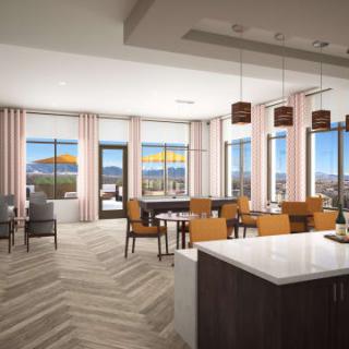 A modern open floor plan living space featuring a kitchen and dining area with large windows providing ample natural light.