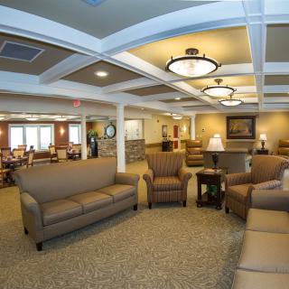 A spacious lobby area featuring comfortable sofas, armchairs, and elegant lighting.