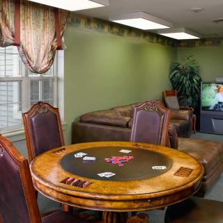 A cozy living room with a poker table and comfortable seating.