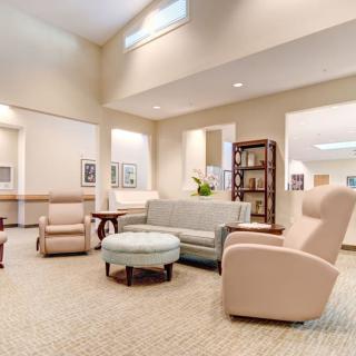 A bright and modern lounge area featuring comfortable seating and decor.