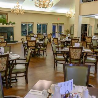An elegant and empty dining area with neatly arranged tables and chairs.