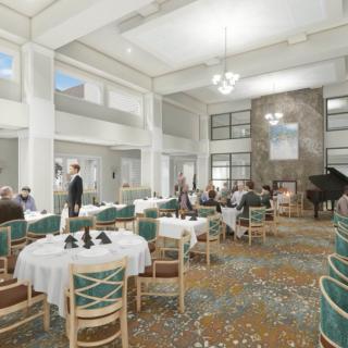 An elegant dining area with tables and chairs, featuring high ceilings and a central chandelier.