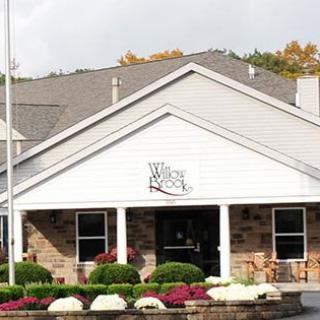 A welcoming entrance of a building with neatly arranged flowers.