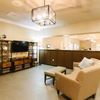 A cozy and modern living room with a TV, comfortable seating, and stylish lighting.