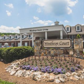 The entrance of Winthrop Court with a landscaped garden and visible signage.
