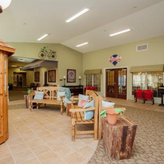 A spacious lobby area with wooden furniture and decorative items.