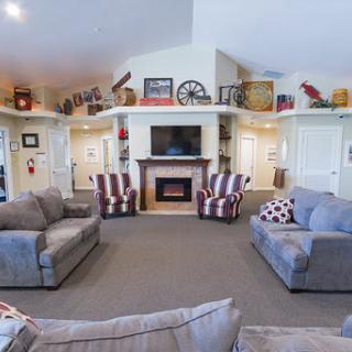A cozy living room with comfortable seating and a welcoming fireplace, perfect for relaxation.