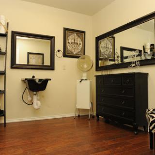 A stylish salon interior featuring elegant decor and functional furniture.