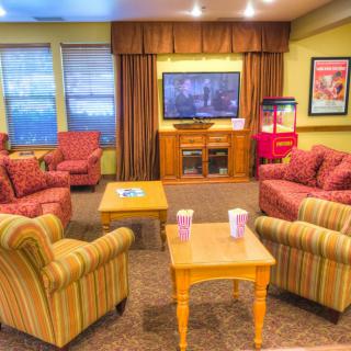 Cozy living room with comfortable seating and a television.