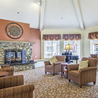 Cozy living room with a stone fireplace and comfortable seating.