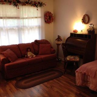 A cozy living room with a red sofa, decorative elements, and warm lighting.