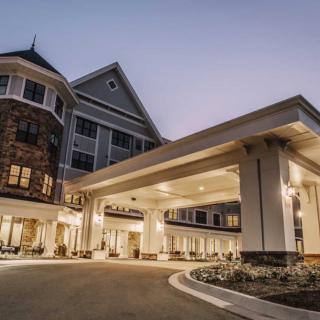 An elegant hotel entrance illuminated during the evening hours.