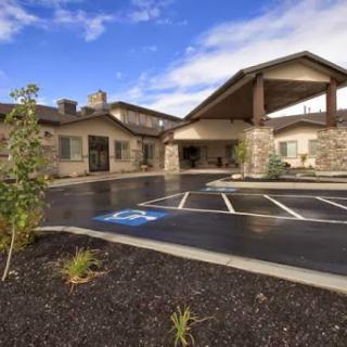 A modern residential facility featuring stone architecture and well-maintained landscaping.