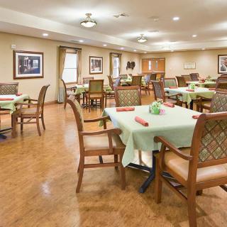 An elegantly arranged dining room with neatly set tables and comfortable chairs.