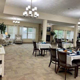 A spacious, well-lit dining area with tables and chairs arranged neatly.