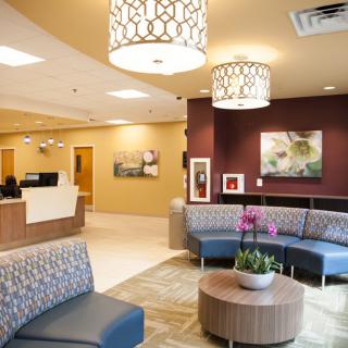 A modern waiting room with comfortable seating and stylish lighting.