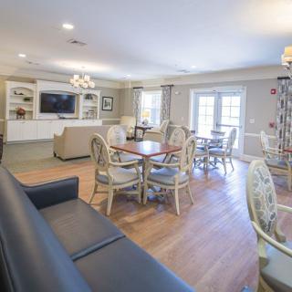 A cozy living and dining area with elegant furniture and bright lighting.
