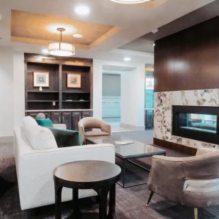 A contemporary living room with comfortable seating and a modern fireplace.