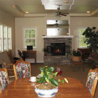 A cozy living room with a fireplace and dining area.