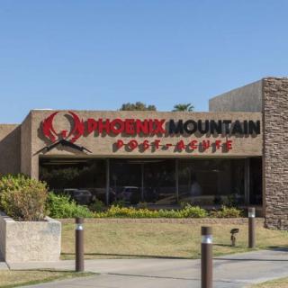 A view of the Phoenix Mountain Post Office building with its sign prominently displayed.
