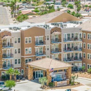 A modern residential apartment complex featuring multiple balconies and a welcoming entrance.