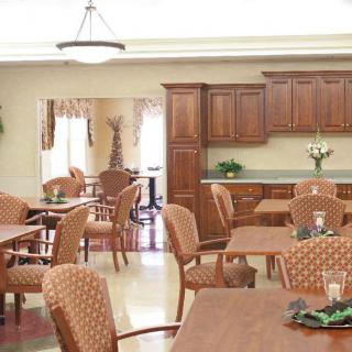 A dining area with wooden furniture and cabinets.