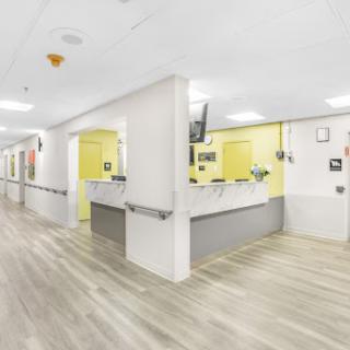 A bright and modern hospital reception area with yellow accents.