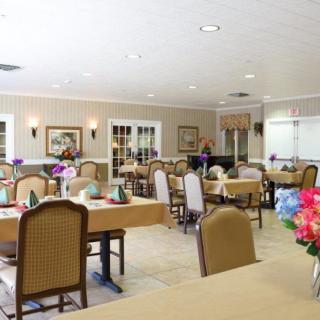 A well-decorated dining area with neatly arranged tables and chairs.