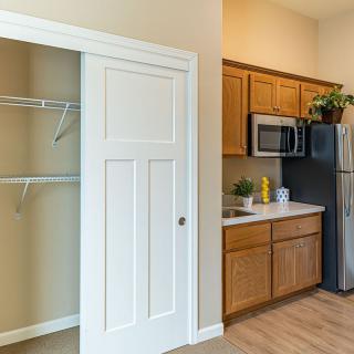Modern apartment kitchen with adjacent closet space.