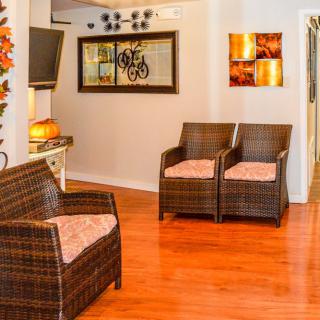 A cozy living room with rattan furniture and warm decor.