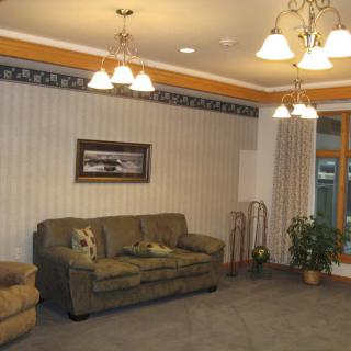 A warmly lit living room featuring a comfortable sofa, elegant lighting fixtures, and tasteful decor.