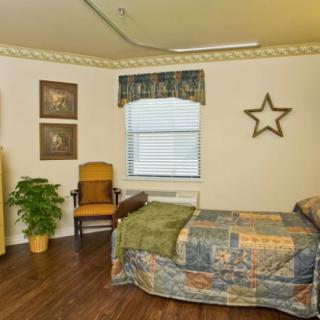 A cozy bedroom with a single bed, wooden chair, and decorative elements like a star on the wall.