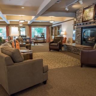 A cozy living room with comfortable seating and a fireplace.